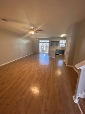 wooden floor in an empty room with a window