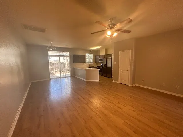 a view of a room with workspace and wooden floor