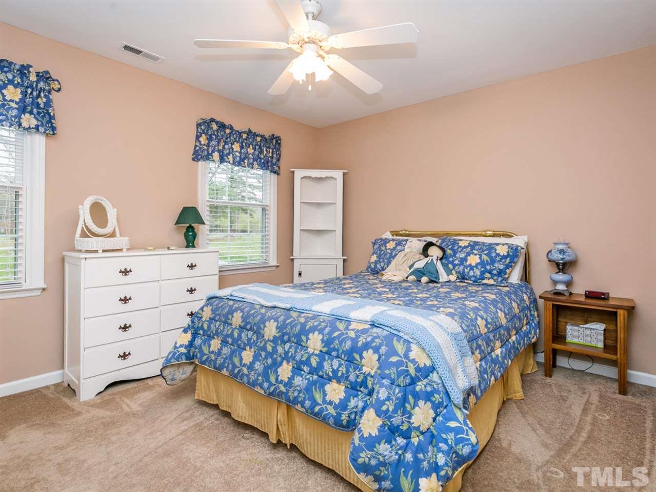 5400 Deep Valley Run Raleigh, NC 27606 - Photo 14 of 25 a bedroom with a bed and a dresser
