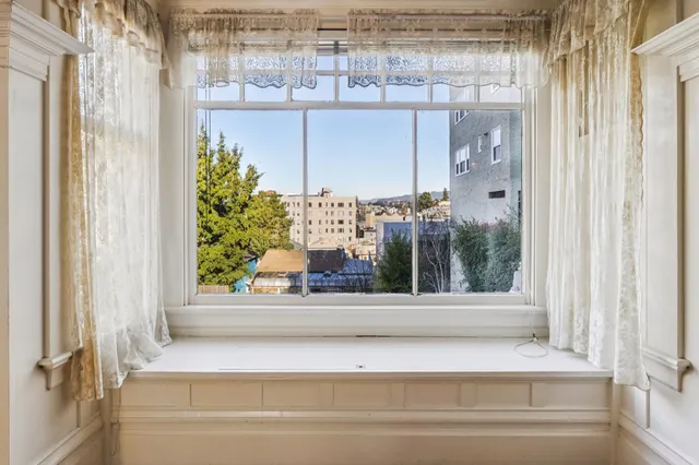 a view of a kitchen with refrigerator and windows