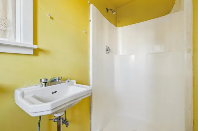 a view of a livingroom with a fireplace and window