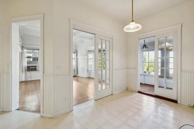 a view of an empty room with a fireplace and a window
