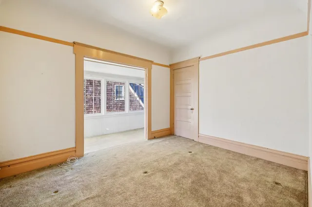 an empty room with windows and closet