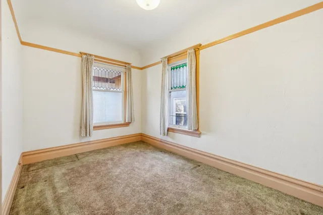 a view of a house with a yard and wooden fence