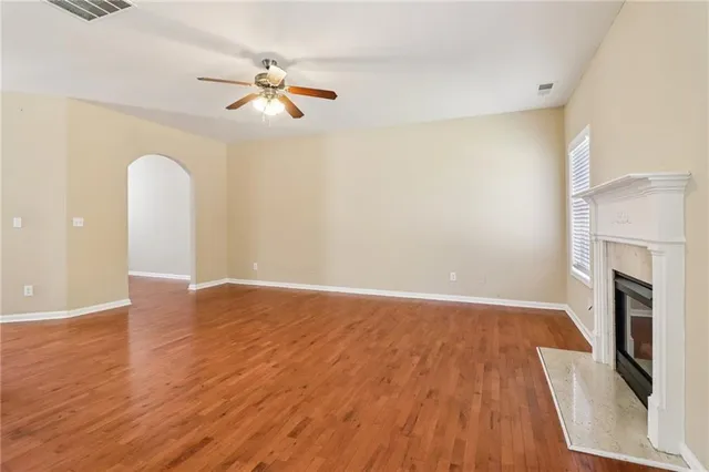 a kitchen with stainless steel appliances granite countertop a stove a sink dishwasher a refrigerator and a oven with wooden cabinets