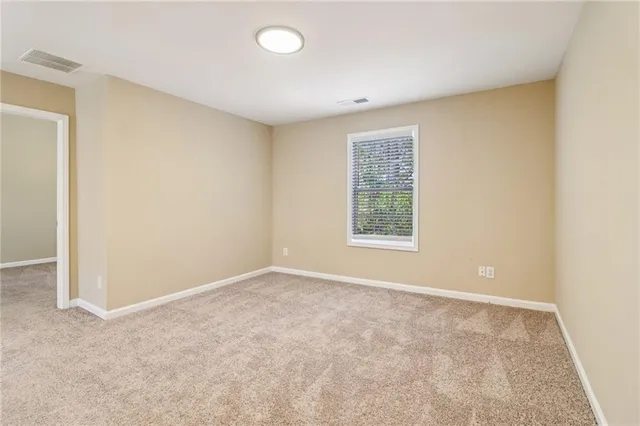 a spacious bathroom with a granite countertop sink a mirror and a shower