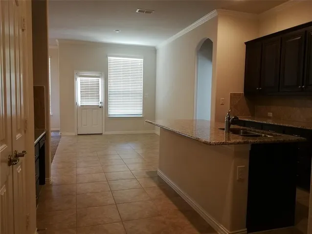 a view of a kitchen with wooden floor and a cabinet