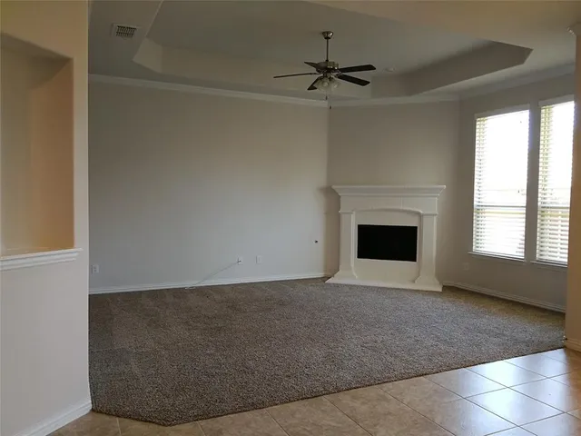 a view of empty room with a fireplace