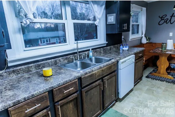 a kitchen with a sink and a stove top oven