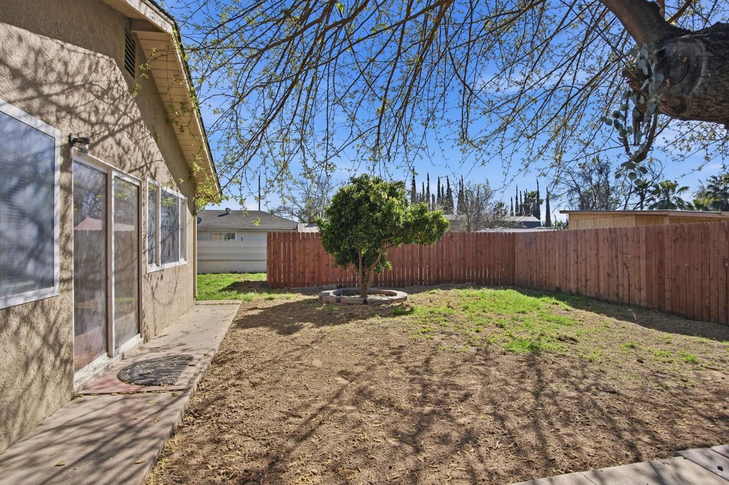 1409 Stonum Road Modesto, CA 95351 - Photo 23 of 40 a backyard of a house with lots of green space