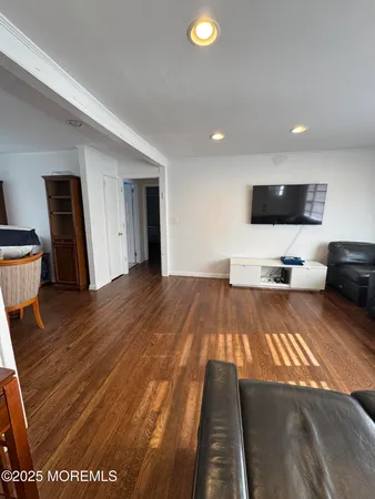 a view of a livingroom with furniture and a flat screen tv
