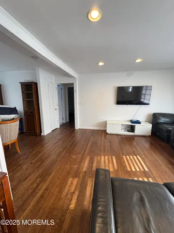 a view of a livingroom with furniture and a flat screen tv