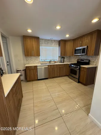 a kitchen with stainless steel appliances granite countertop a sink and cabinets