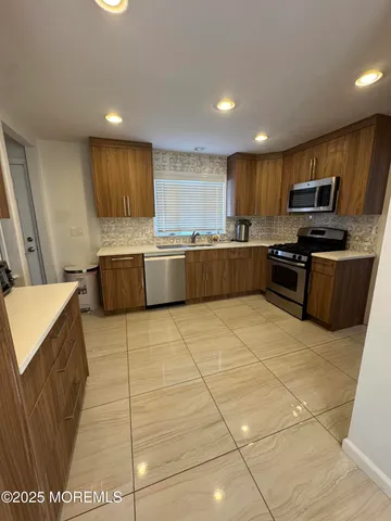 a kitchen with stainless steel appliances granite countertop a sink and cabinets
