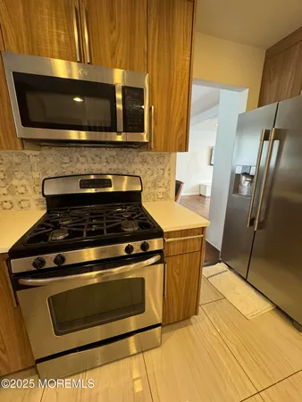 a stove top oven sitting inside of a kitchen