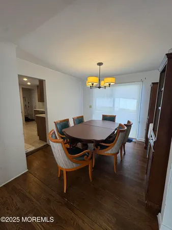 a view of a dining room with furniture and a chandelier