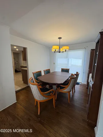 a view of a dining room with furniture and a chandelier