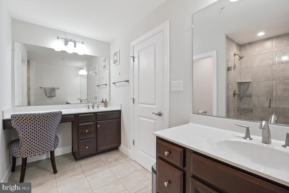 2945 Duvall Ridge Road, Unit 573 Hyattsville, MD 20785 - Photo 14 of 23 a spacious bathroom with a sink double vanity and a mirror