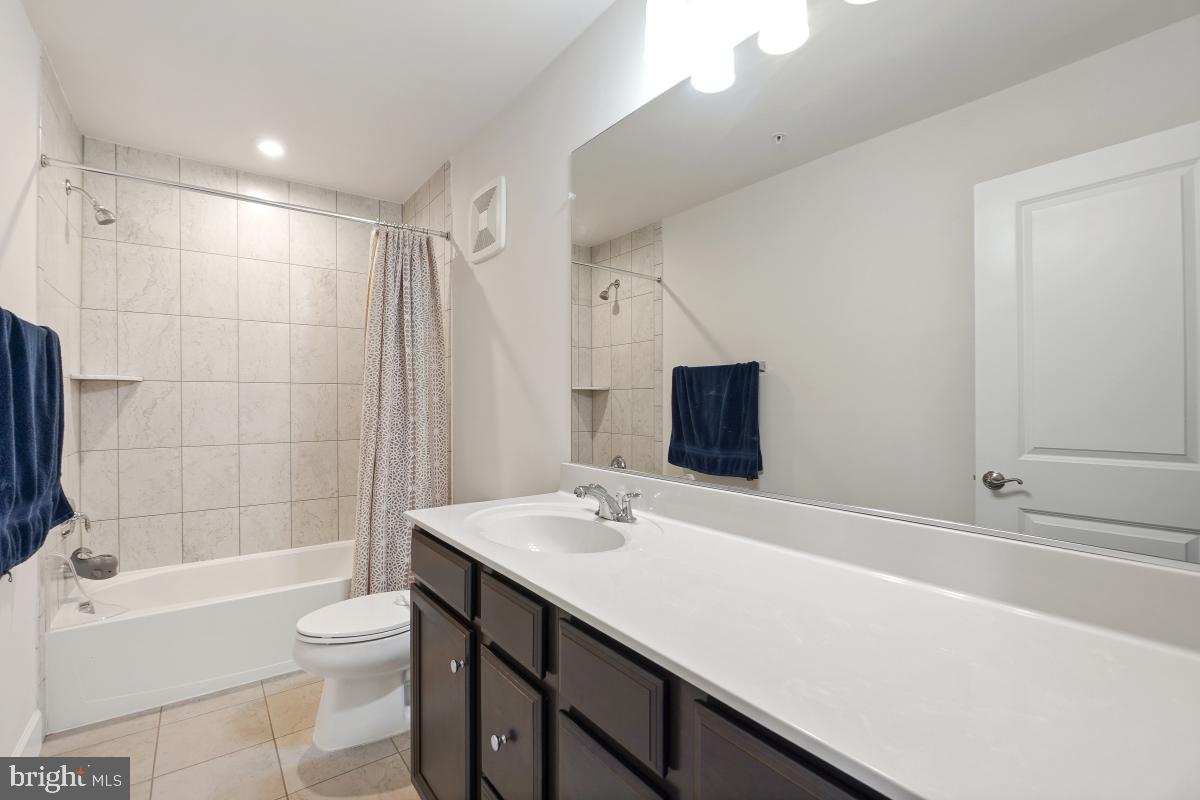 2945 Duvall Ridge Road, Unit 573 Hyattsville, MD 20785 - Photo 18 of 23 a bathroom with a sink a toilet and shower