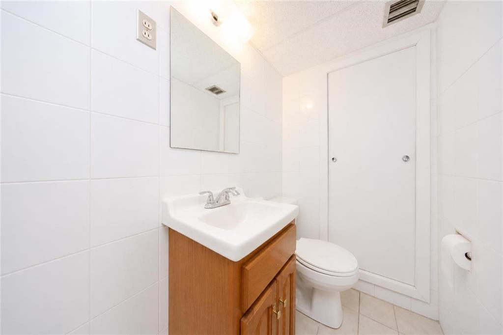 1 Bay Ridge Parkway Brooklyn, NY 11209 - Photo 31 of 38 a bathroom with a toilet sink vanity and mirror