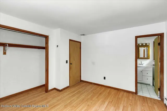 a view of an empty room and wooden floor