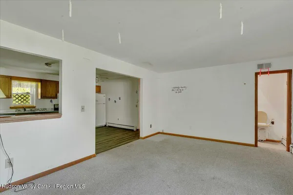 a kitchen with stainless steel appliances granite countertop a refrigerator a stove top oven a sink dishwasher and white cabinets with wooden floor