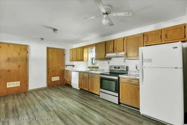 an empty room with wooden floor and closet