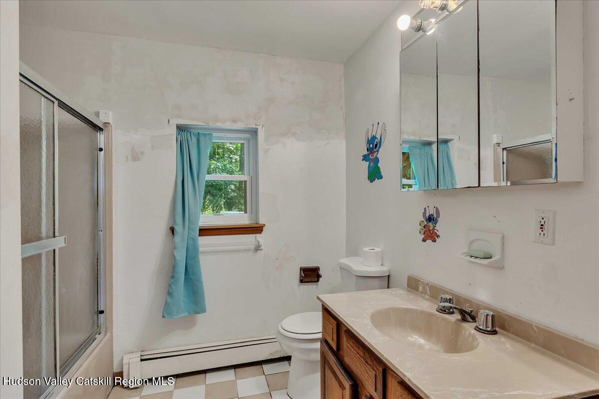 35 Banta Lane Cairo, NY 12413 - Photo 28 of 33 a bathroom with a granite countertop sink a toilet and a mirror