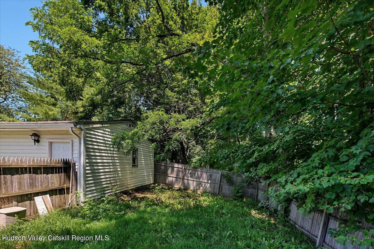 35 Banta Lane Cairo, NY 12413 - Photo 32 of 33 a small yard with large trees and a wooden fence