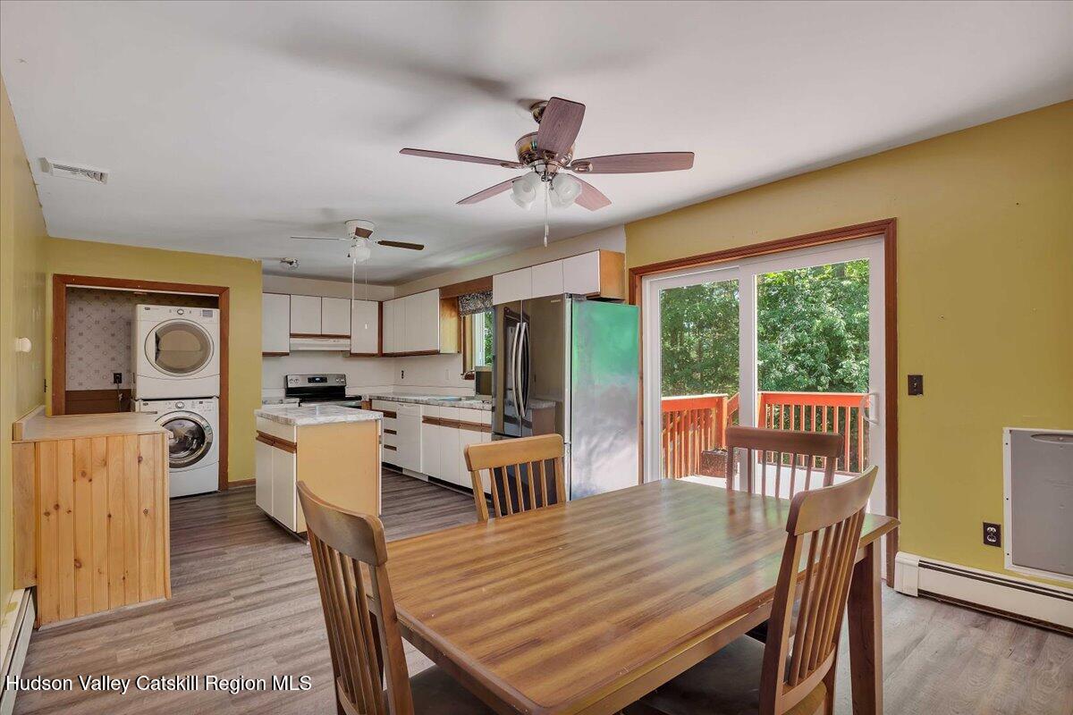 35 Banta Lane Cairo, NY 12413 - Photo 8 of 33 a dining room with wooden floor a chandelier fan a wooden table and chairs