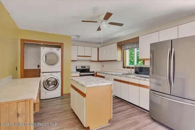 a kitchen with a refrigerator a stove a sink and a stove