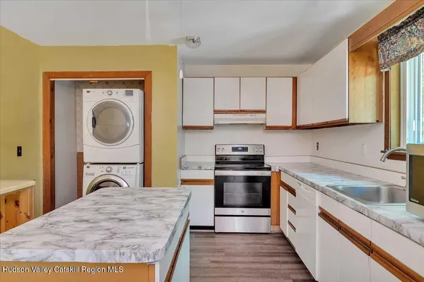 a kitchen with a stove a sink and a microwave