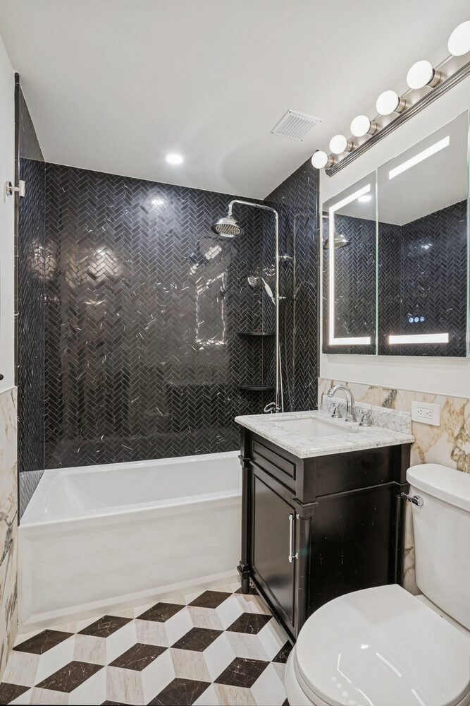 116 East 66th Street, Unit 3E Manhattan, NY 10065 - Photo 8 of 10 a bathroom with a sink a toilet and shower