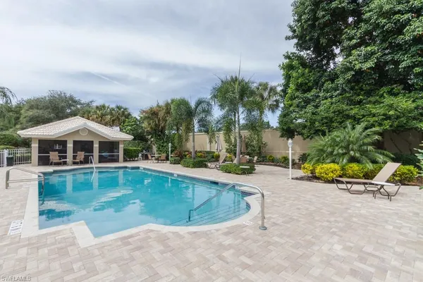 an aerial view of a house with swimming pool and porch