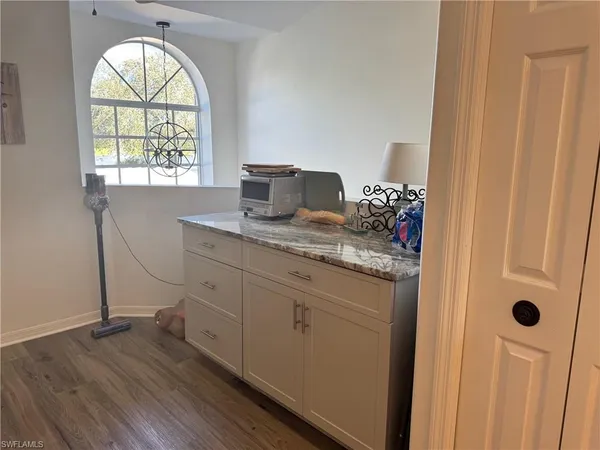 a hall with a window a sink and a window