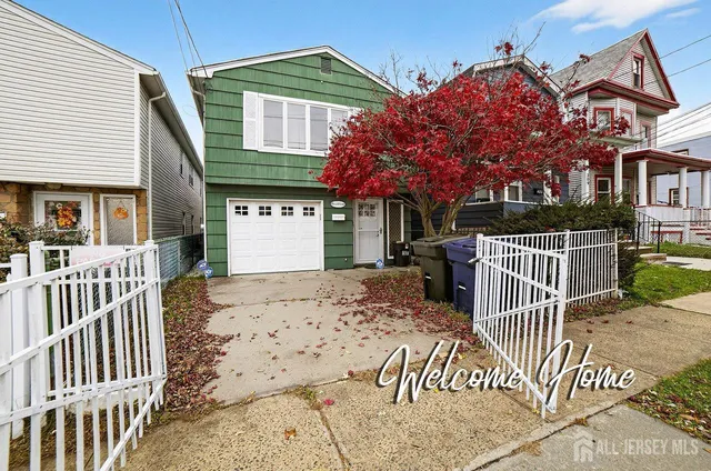 a view of a house with a wooden fence