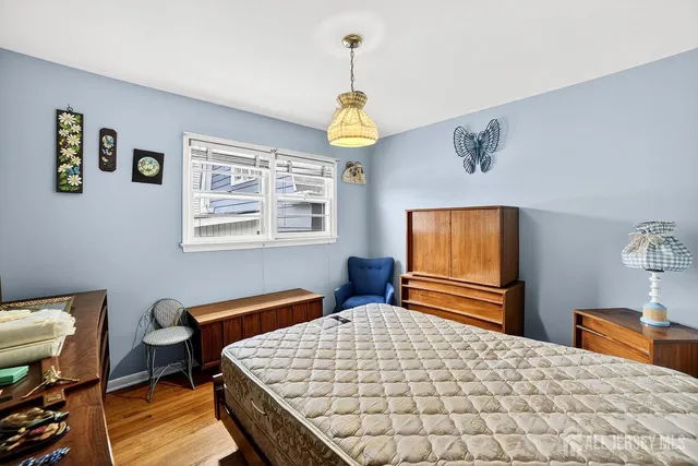 a bedroom with bed and window