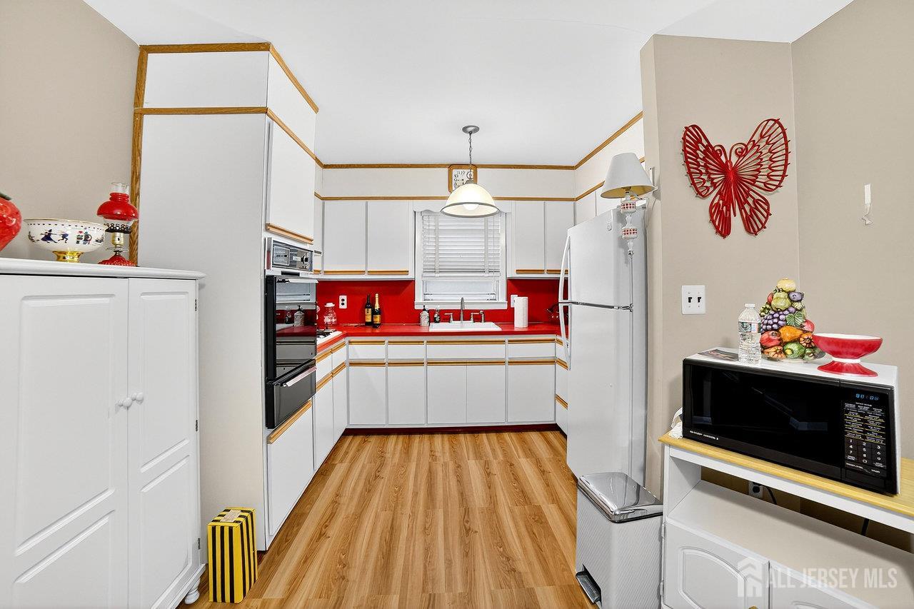 307 Sutton Street Perth Amboy, NJ 08861 - Photo 14 of 27 a storage room with cabinets and wooden floor