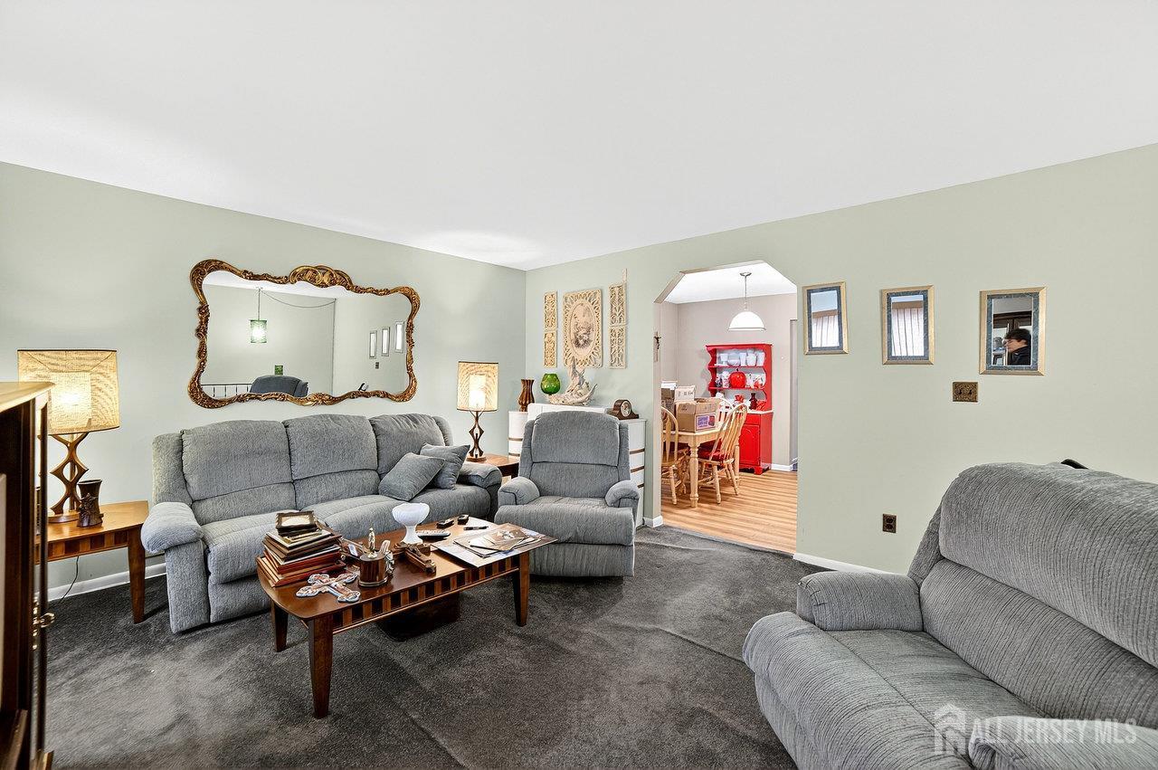 307 Sutton Street Perth Amboy, NJ 08861 - Photo 18 of 27 a living room with furniture and a chandelier