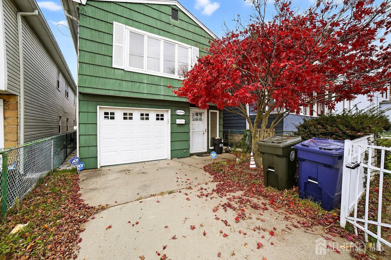 307 Sutton Street Perth Amboy, NJ 08861 - Photo 2 of 27 a front view of a house with a yard
