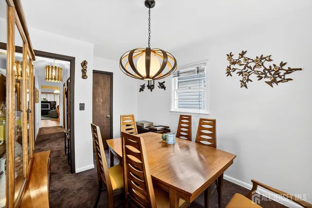 a view of a dining room with furniture and a chandelier