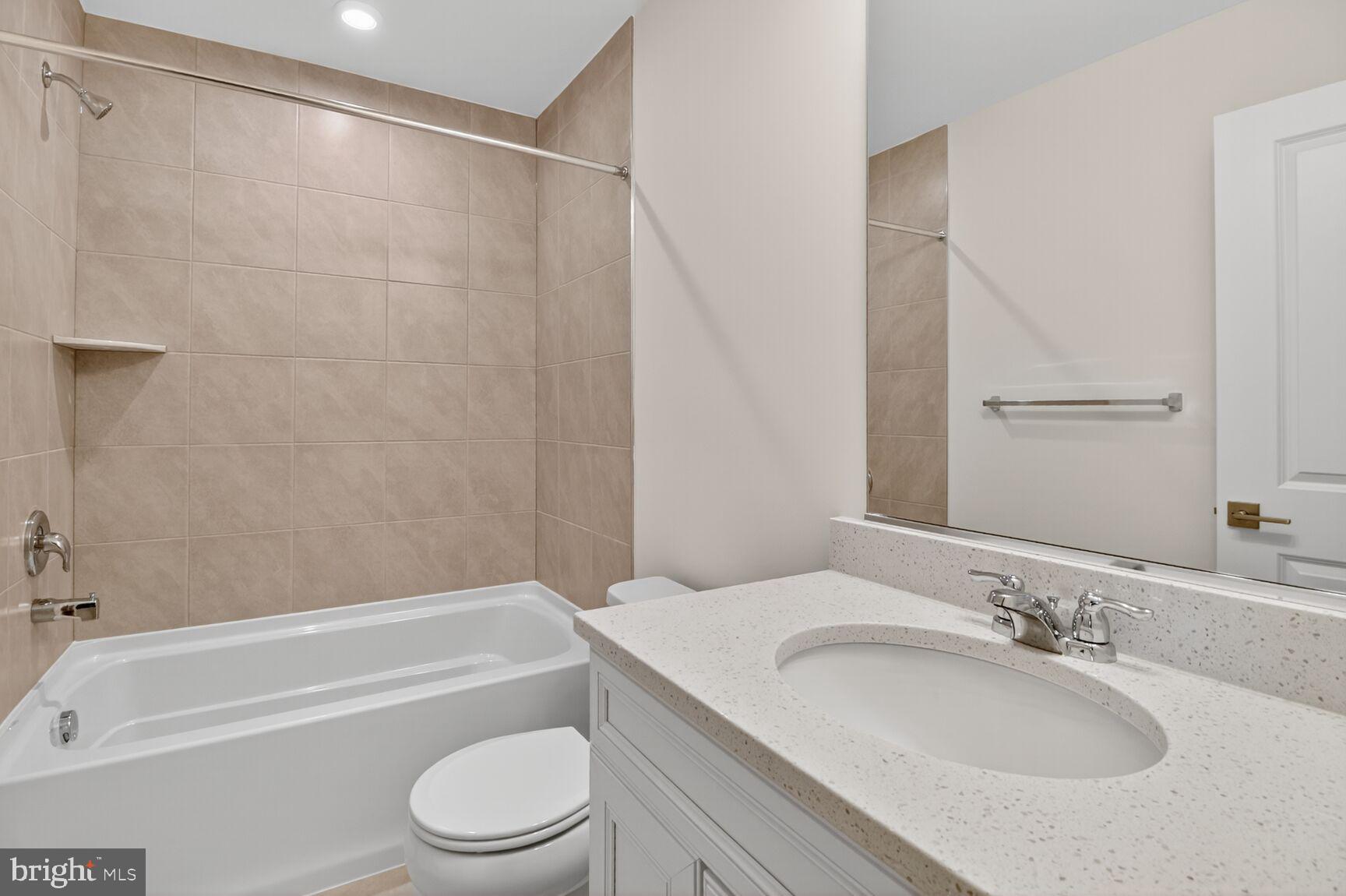 1802 John Stricker Avenue Baltimore, MD 21222 - Photo 12 of 47 a bathroom with a granite countertop bathtub shower sink vanity and toilet