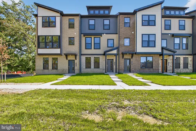 a view of a brick building next to a yard