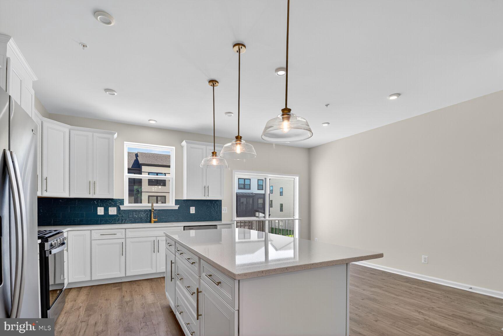 1802 John Stricker Avenue Baltimore, MD 21222 - Photo 5 of 47 a large kitchen with stainless steel appliances granite countertop a stove a sink and a chandelier