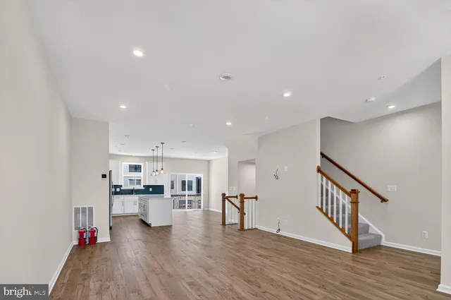 a view of kitchen with wooden floor and electronic appliances
