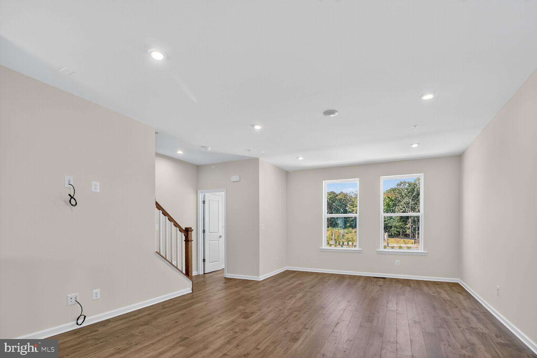 1802 John Stricker Avenue Baltimore, MD 21222 - Photo 7 of 47 an empty room with wooden floor and windows