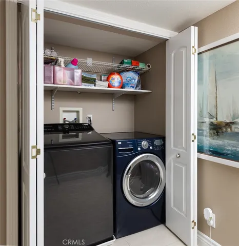 a utility room with sink dryer and washer