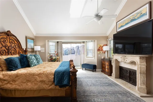 a bed room with a bed a television and fireplace