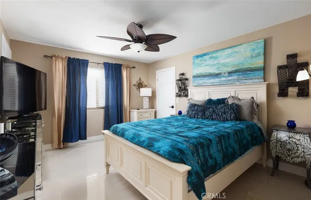 a bedroom with bed and a chandelier