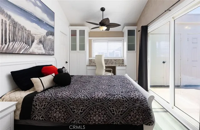 a bedroom with a bed and a large window